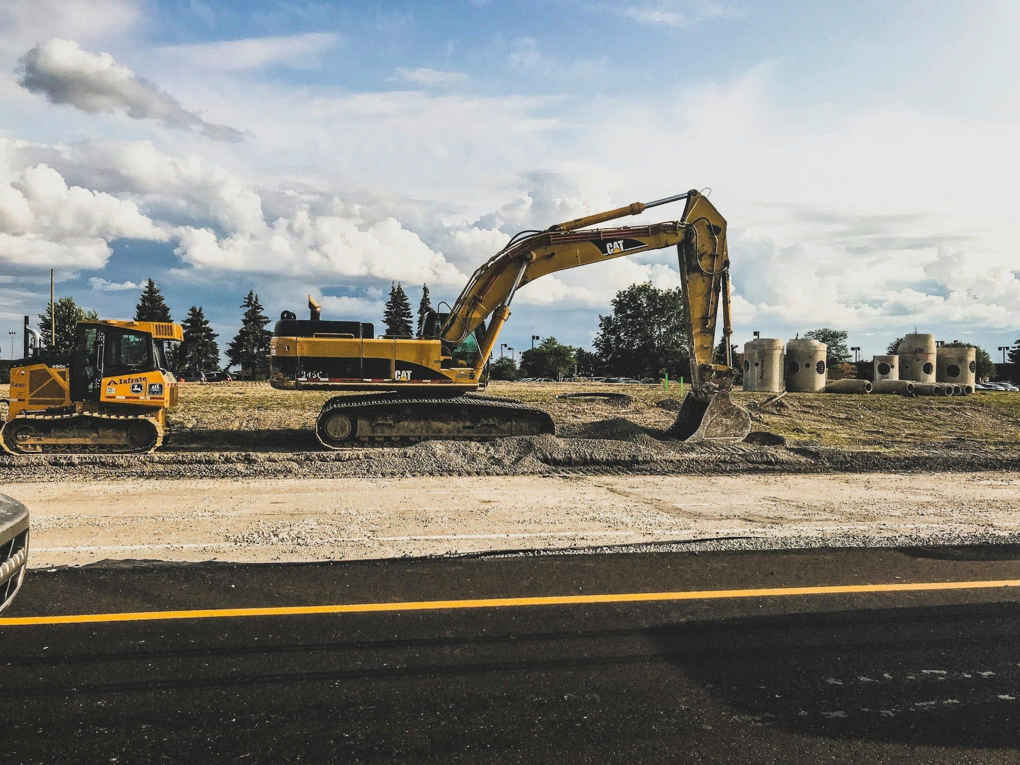 Tracked excavator moving earth on a graded sitework job