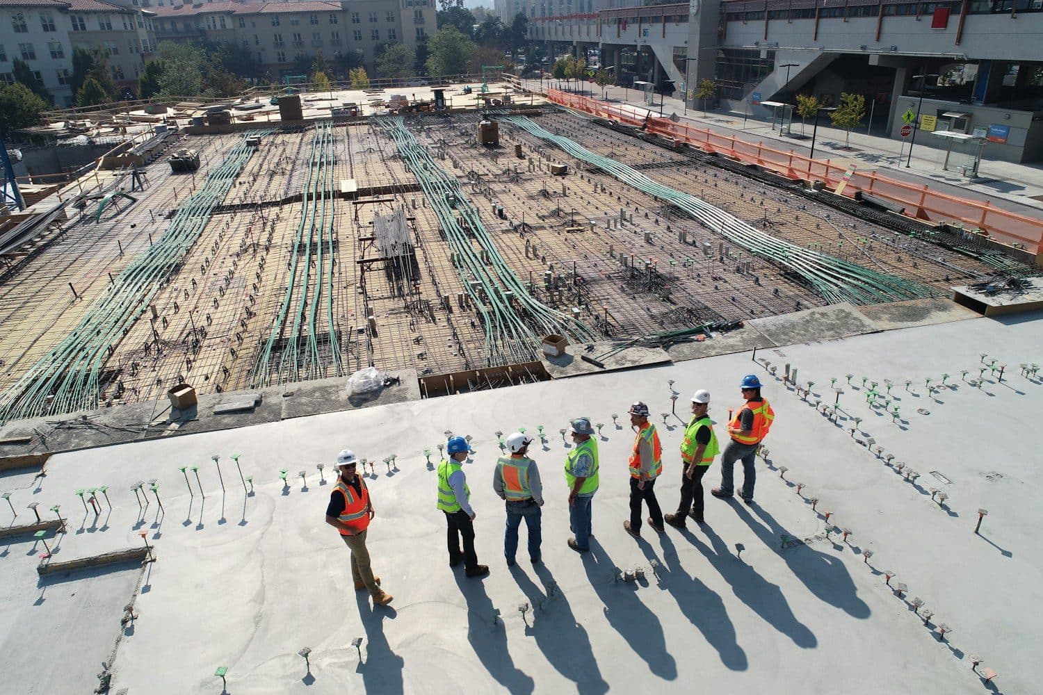 GRH crew walking a poured deck on site